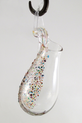 Blown Glass vase, made for suspending from hooks or nails with ribbon. When filled with water, texture on back magnifies. Fill with fresh or dried flowers, root house plants or use as a scented oil diffuser. Approx. 5-7" tall