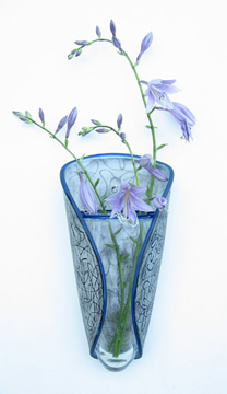 Wall vase made to hang from nail. Blown glass and hot formed. Engraved surface design. Approx. 8"L x 4" W x 3" D