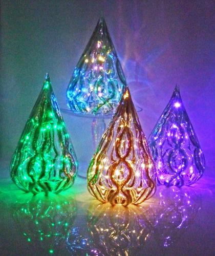 Modern implied tree shaped lantern. Fill base with LED string lights for a festive display (lights not included but optional with purchase). Approx. 8-9"h x 4.5-5" w