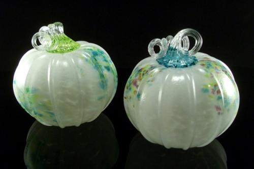 Opaque white pumpkin with multicolor accent marks. Approx. 6" x 6" 